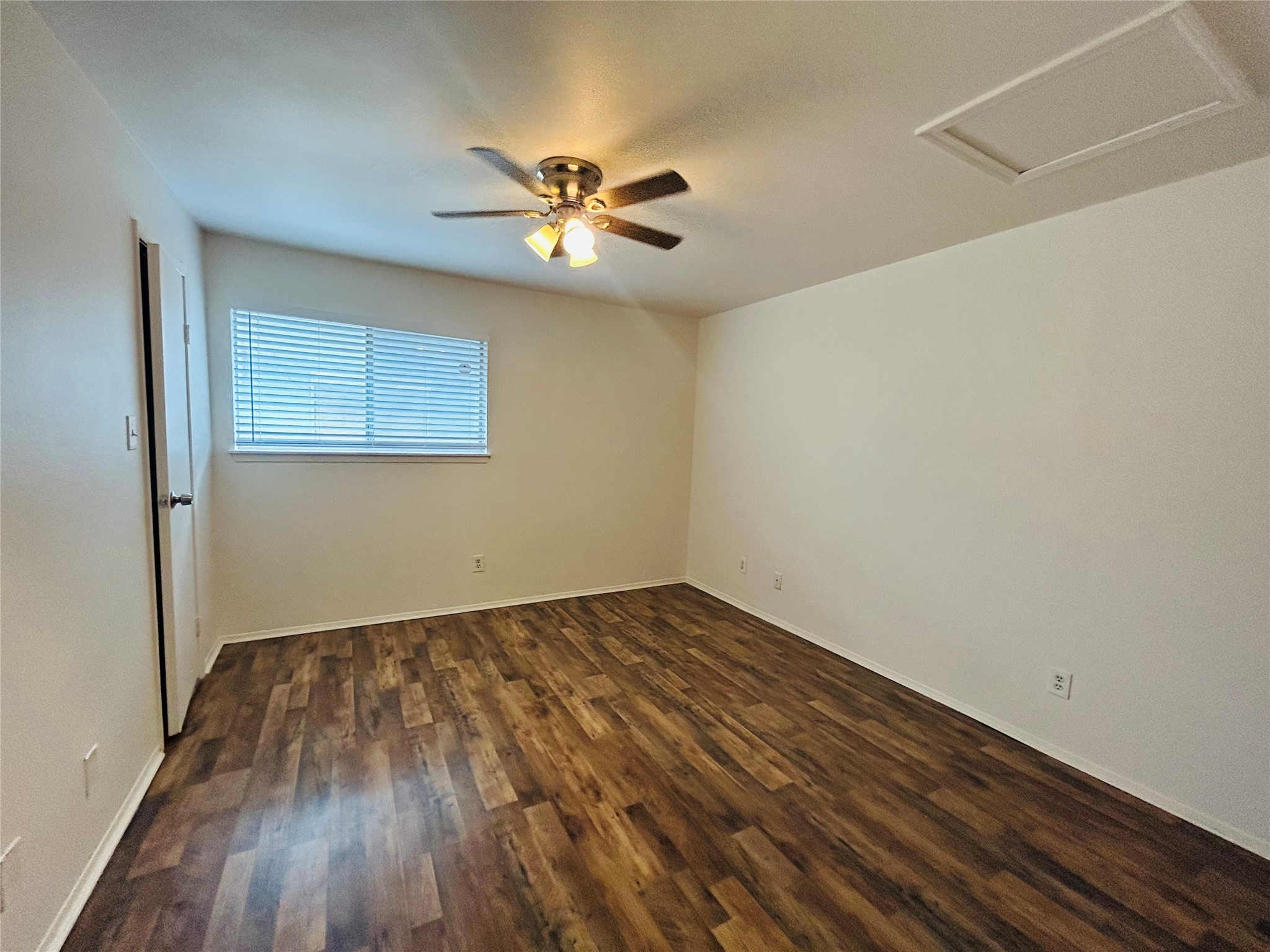 8030 Sands Point Drive, Unit D Houston, TX 77036 - Photo 7 of 24 a view of an empty room with wooden floor and a chandelier fan