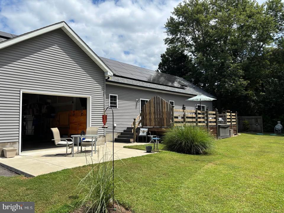 5549 Bonnie Brook Road Cambridge, MD 21613 - Photo 2 of 28 a view of a patio with table and chairs potted plants and a large tree