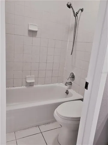 a bathroom with a bathtub a toilet and a shower