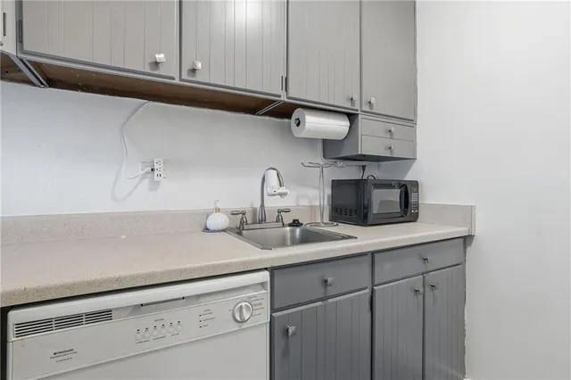 a kitchen with a white stove top oven and refrigerator