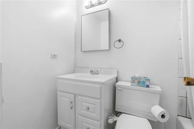 a bathroom with a sink toilet and a mirror