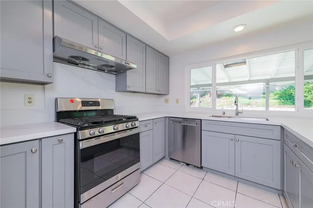 a kitchen with cabinets a stove and a sink