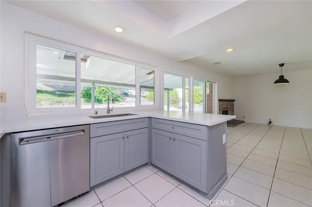 a kitchen with a sink window and cabinets