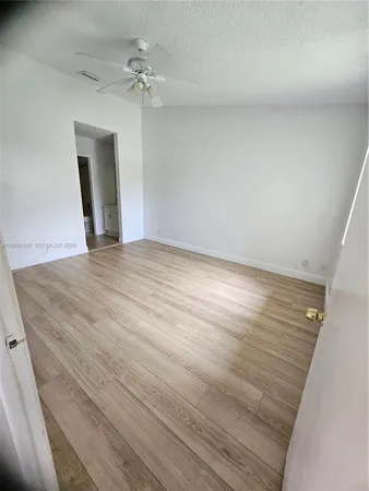 walk in closet with wooden floor washer and dryer