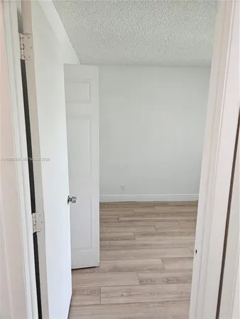 a view of a hallway view with wooden floor and staircase