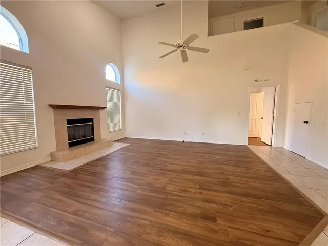 a view of a room with wooden floor and window