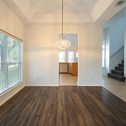 a kitchen with stainless steel appliances a stove top oven a sink a counter top space and cabinets