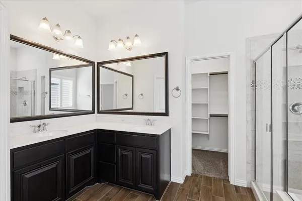 a kitchen with a sink cabinets and wooden floor