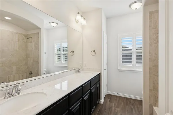a bathroom with a sink double vanity and a mirror