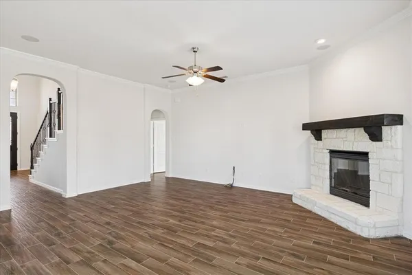 wooden floor in an empty room with a fireplace