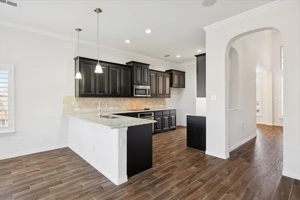 a kitchen with stainless steel appliances granite countertop a stove and a refrigerator