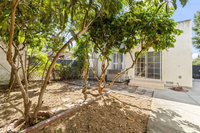 a view of house with backyard and trees