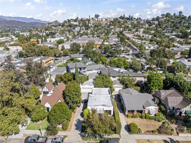 an aerial view of residential houses with outdoor space and street view