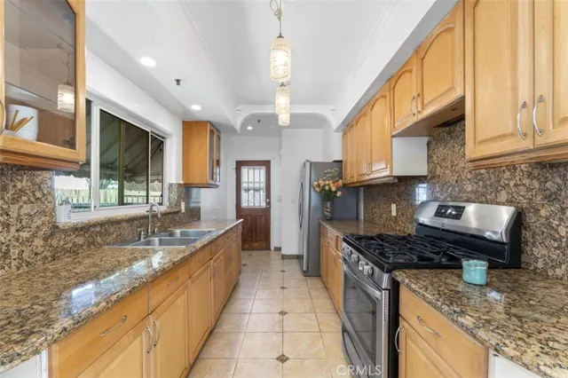 a kitchen with stainless steel appliances granite countertop a sink and a counter