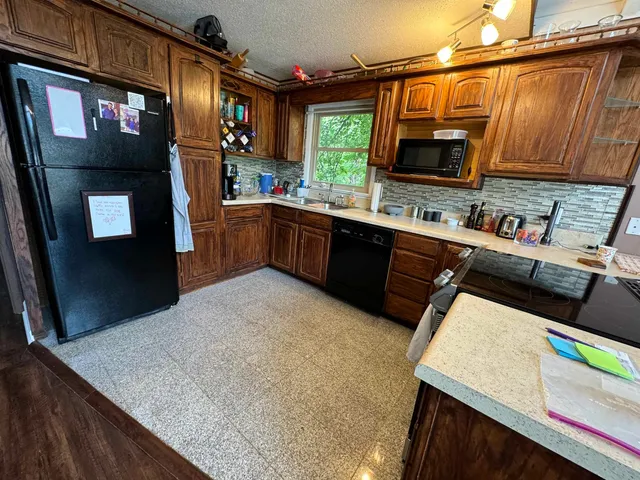 a kitchen with stainless steel appliances a microwave a stove and refrigerator