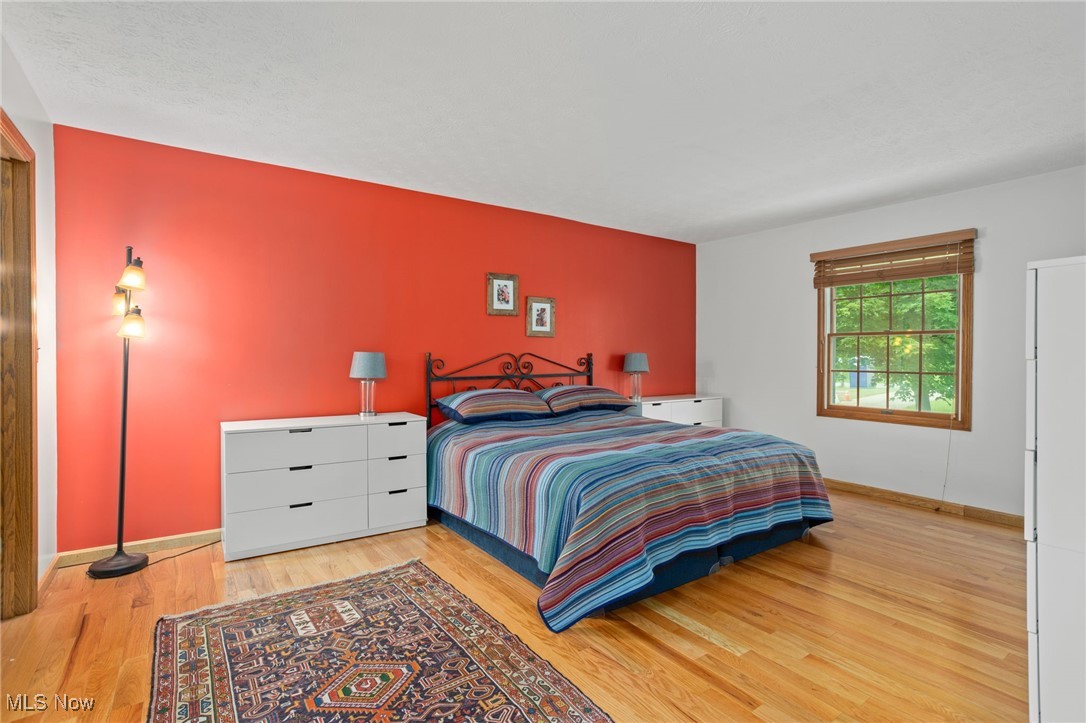 4694 Ranchwood Road Akron, OH 44333 - Photo 27 of 44 Bedroom featuring wood finished floors and baseboards