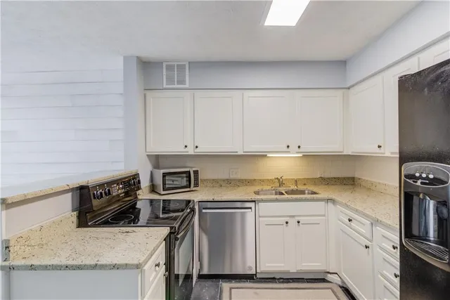 a view of a livingroom with wooden floor & closet area