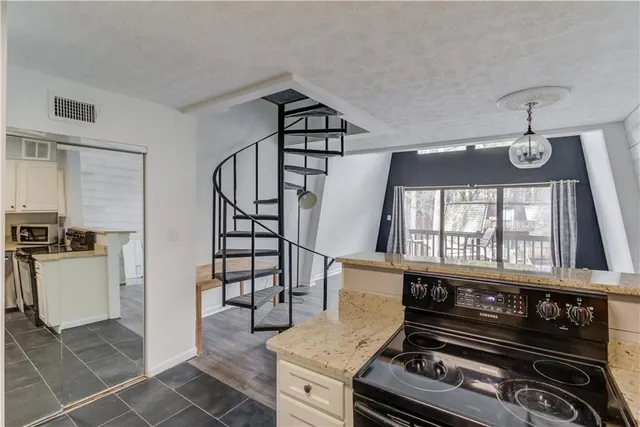 a view of a deck with couches and table and chairs with wooden fence
