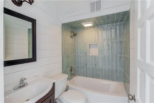 a living room with a bed and painting on the wall