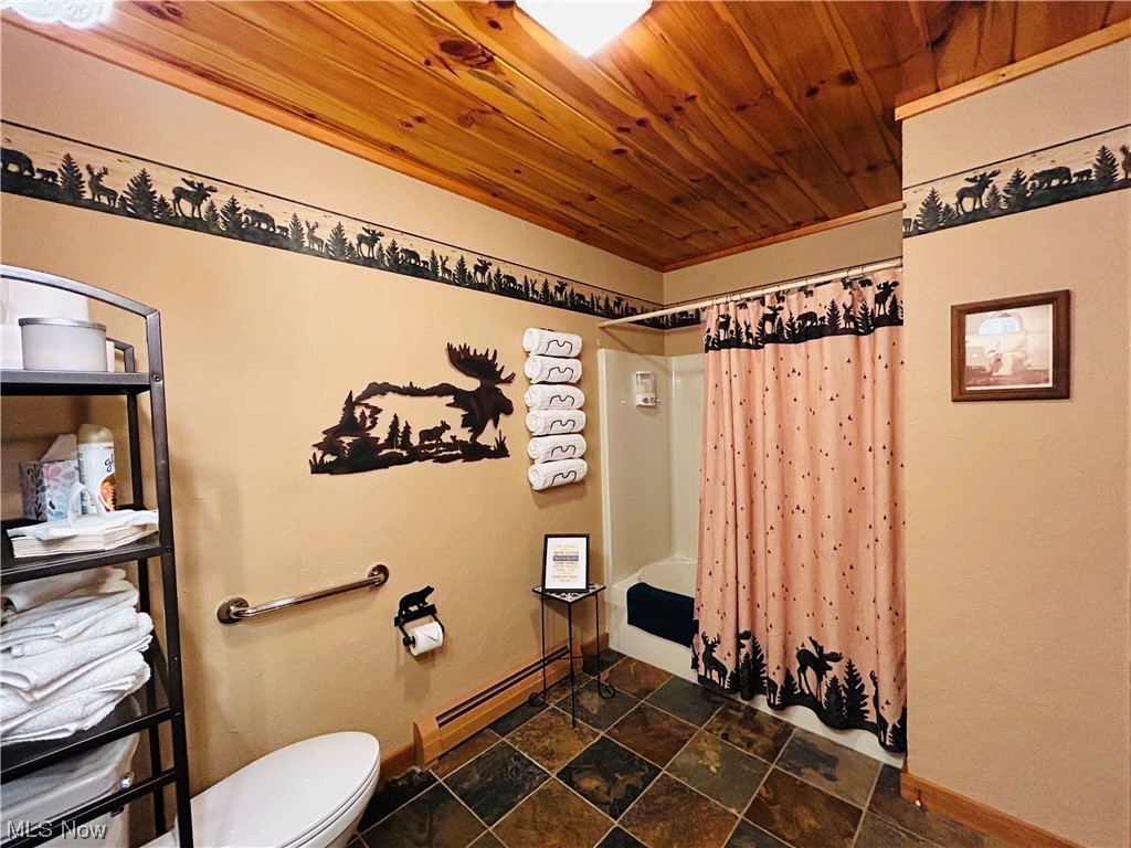 17367 Reeves Road Middlefield, OH 44062 - Photo 20 of 35 Bathroom with tile flooring, toilet, shower / bathtub combination with curtain, wood ceiling, and a baseboard radiator
