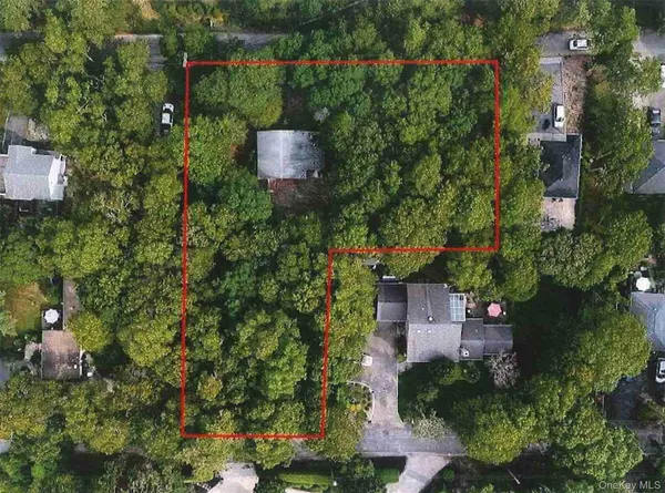 an aerial view of a house with a yard and lake view