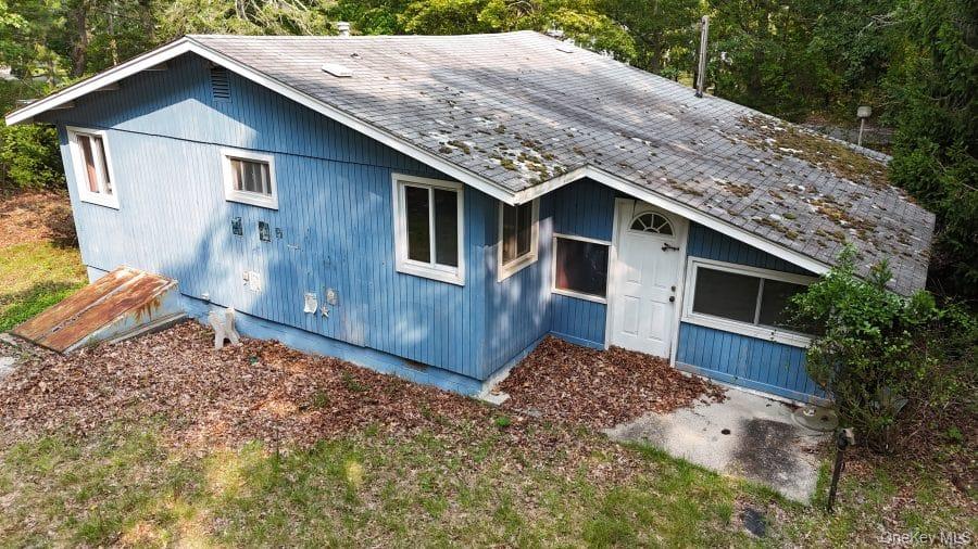 51 Shore Road Hampton Bays, NY 11946 - Photo 2 of 19 a front view of a house with a yard