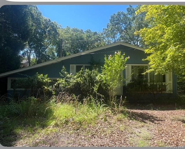 51 Shore Road Hampton Bays, NY 11946 - Photo 3 of 19 a view of a garden