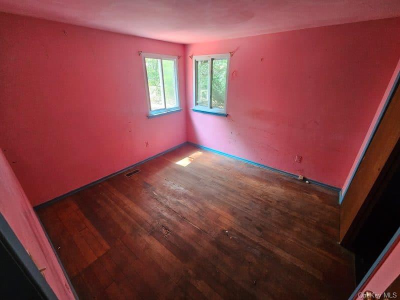 51 Shore Road Hampton Bays, NY 11946 - Photo 8 of 19 a view of an empty room with wooden floor and a window