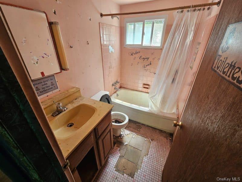 51 Shore Road Hampton Bays, NY 11946 - Photo 9 of 19 a bathroom with a sink a toilet and shower