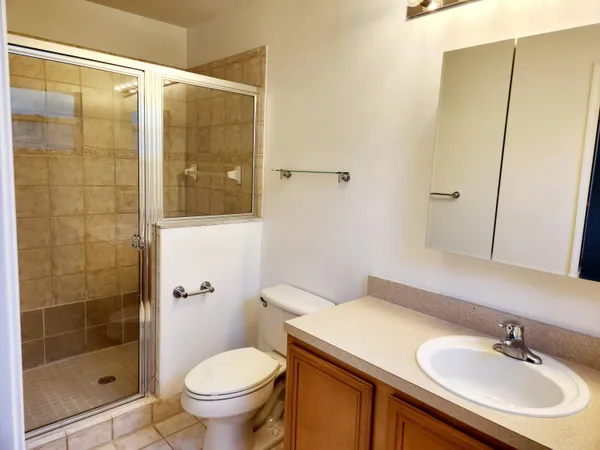 a bathroom with a sink toilet and shower