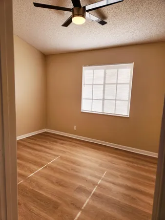 an empty room with a empty space and windows