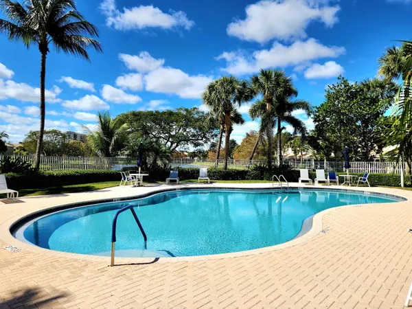 a view of a swimming pool with a yard