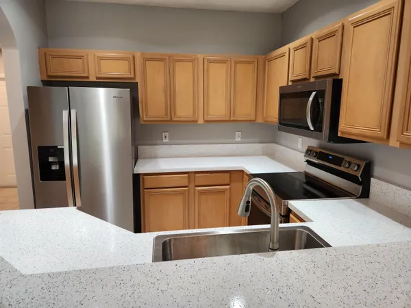 a kitchen with a refrigerator and a sink