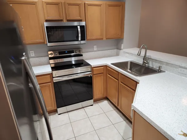 a kitchen with a sink stove and microwave