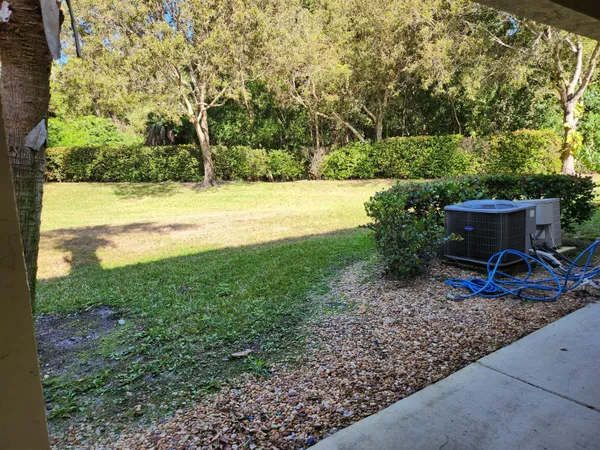 a view of a backyard with a garden and entertaining space