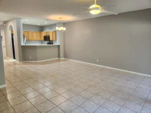 a view of kitchen with granite countertop cabinets and window