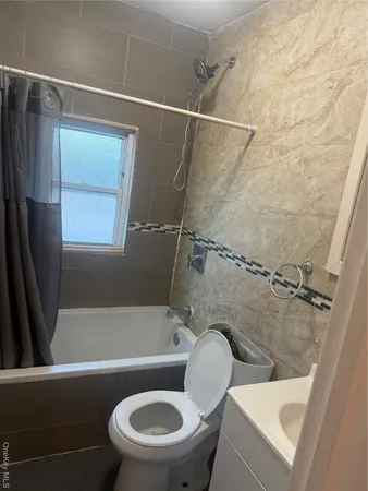 a bathroom with a sink a toilet a mirror and a bathtub