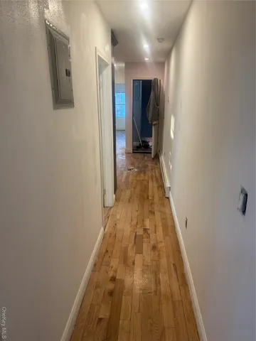 a view of hallway with wooden floor