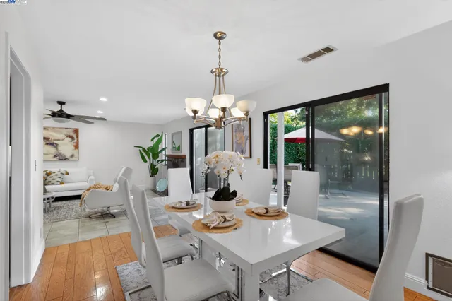 a view of a dining room with furniture wooden floor and a chandelier