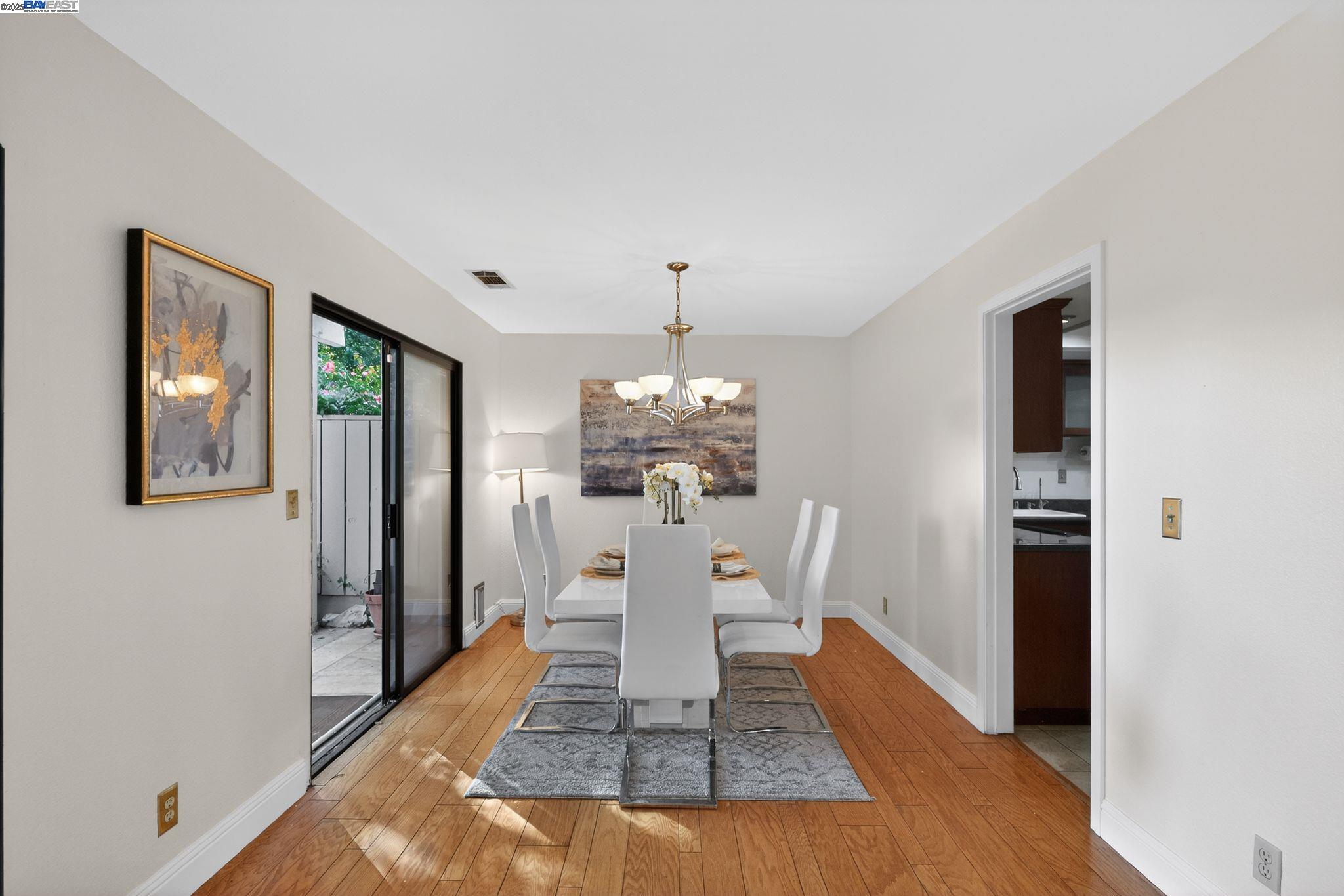 7210 Valley View Court Pleasanton, CA 94588 - Photo 14 of 44 a dining room with chandelier and wooden floor