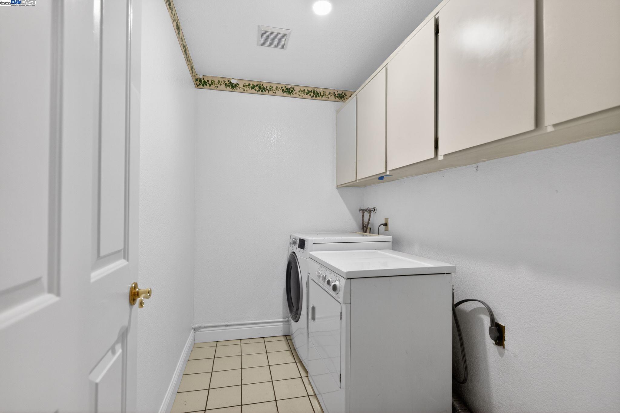 7210 Valley View Court Pleasanton, CA 94588 - Photo 29 of 44 a utility room with a sink a washer and dryer