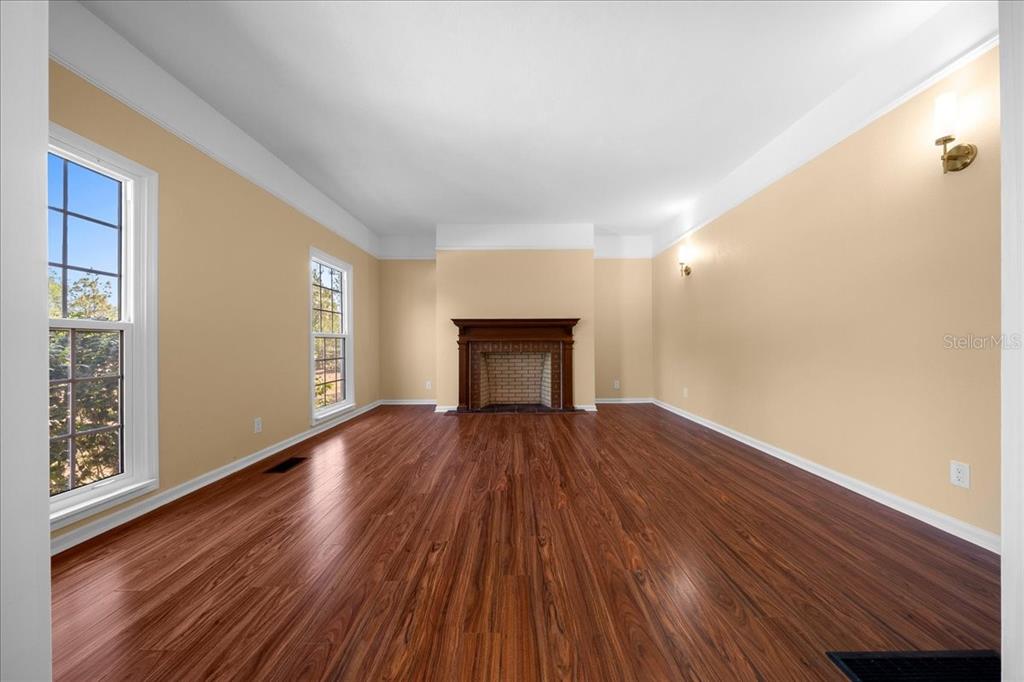 7808 Northeast 75th Street Gainesville, FL 32609 - Photo 12 of 78 a view of an empty room with wooden floor and a window