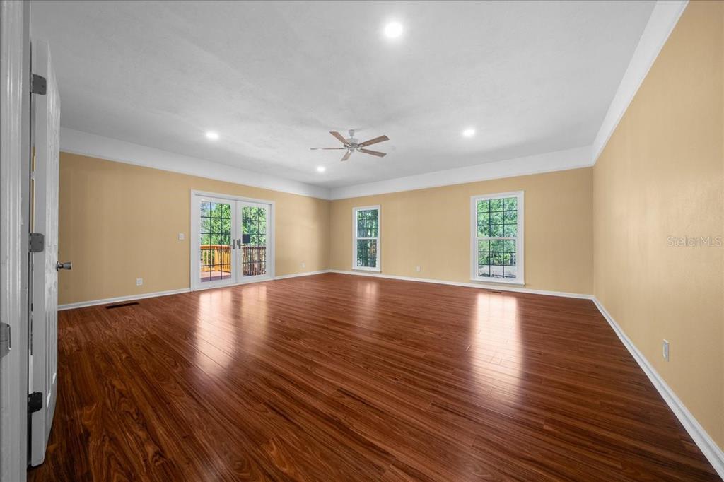 7808 Northeast 75th Street Gainesville, FL 32609 - Photo 22 of 78 a view of an empty room with wooden floor and a window