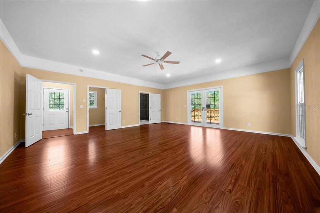 7808 Northeast 75th Street Gainesville, FL 32609 - Photo 23 of 78 a view of an empty room with wooden floor and a window