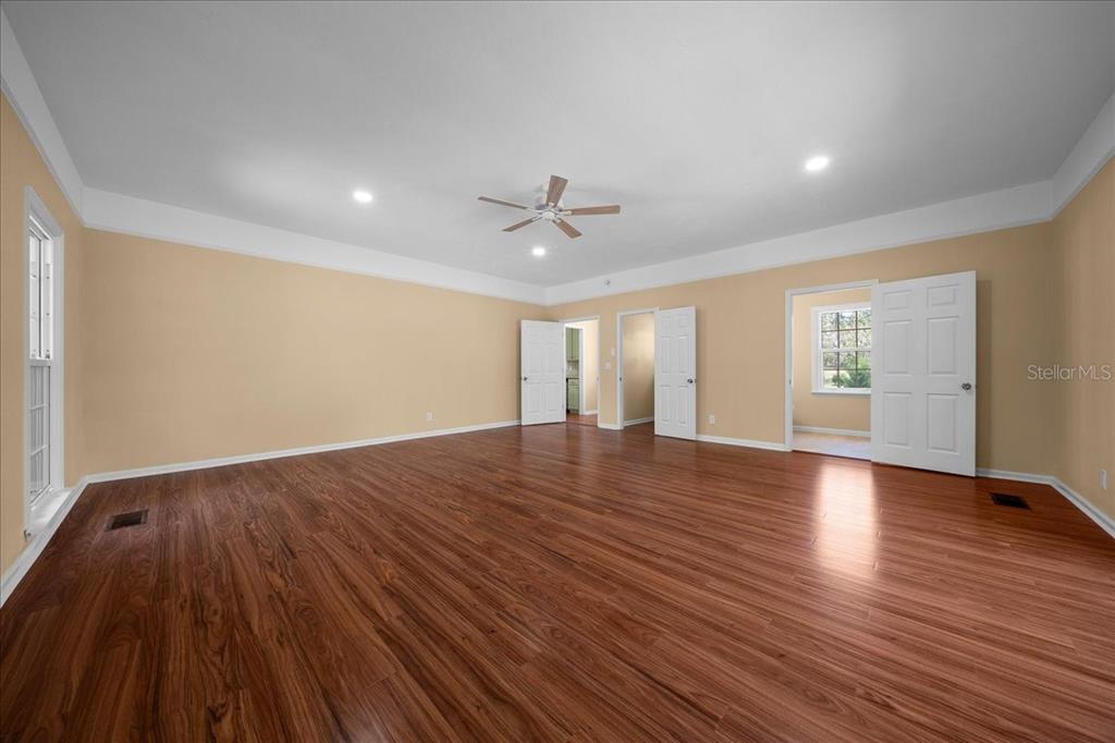 7808 Northeast 75th Street Gainesville, FL 32609 - Photo 24 of 78 a view of an empty room with window and wooden floor