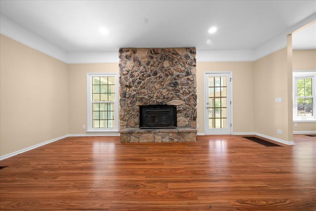 7808 Northeast 75th Street Gainesville, FL 32609 - Photo 30 of 78 an empty room with windows and a fireplace