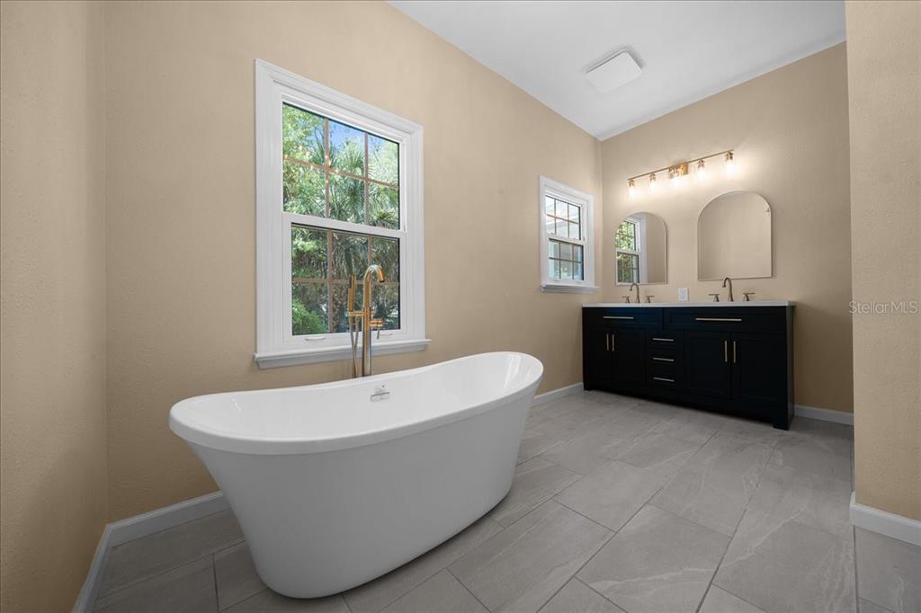 7808 Northeast 75th Street Gainesville, FL 32609 - Photo 35 of 78 a spacious bathroom with a tub sink and mirror
