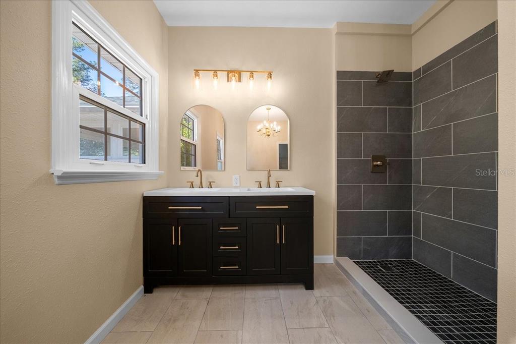 7808 Northeast 75th Street Gainesville, FL 32609 - Photo 37 of 78 a bathroom with a sink vanity and a mirror