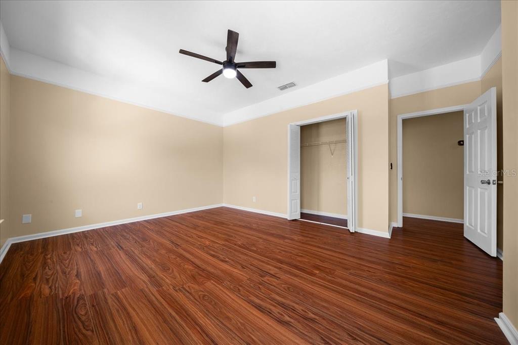 7808 Northeast 75th Street Gainesville, FL 32609 - Photo 38 of 78 a view of empty room with wooden floor and ceiling fan