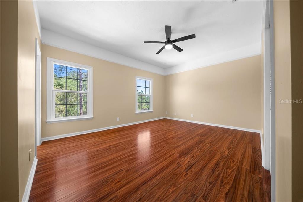 7808 Northeast 75th Street Gainesville, FL 32609 - Photo 43 of 78 a view of empty room with wooden floor and fan
